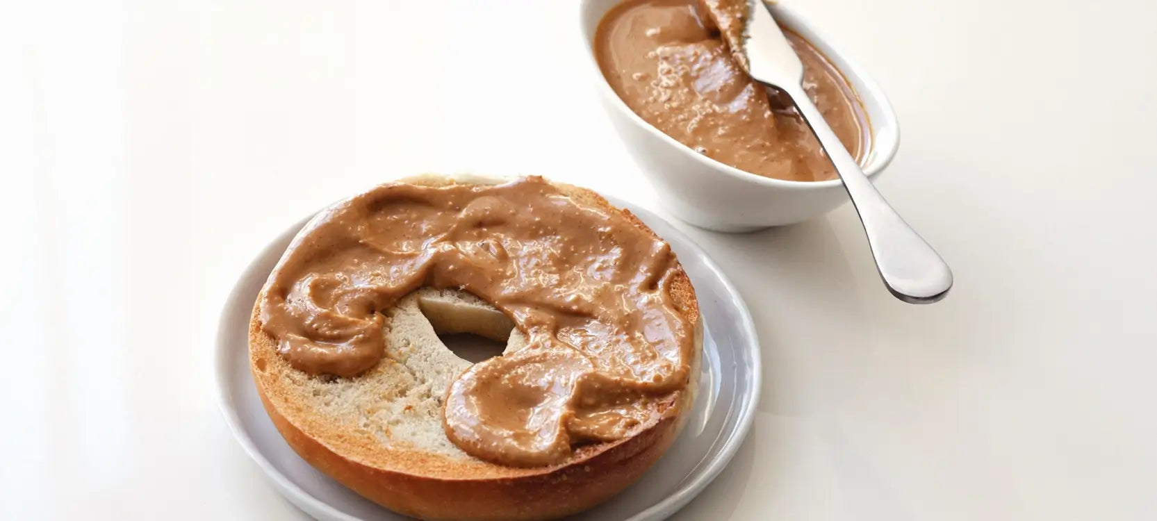 image of freshly toasted bagel with a layer of smooth, home made almond butter